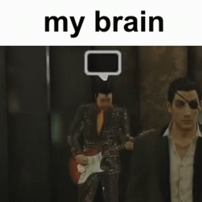 Man In Suit Playing Guitar With Another Man Behind GIF