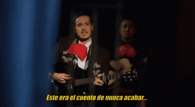 Man In Suit Playing Guitar With Never Ending Story GIF