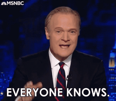 Man in Suit Pointing and Saying Everyone Knows
