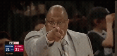 Man In Suit Pointing At Camera During Basketball Game GIF