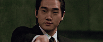 Man In Suit Pointing At Camera Green Background GIF
