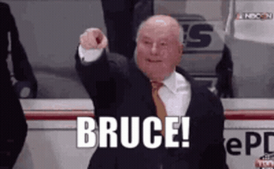 Man In Suit Pointing At Camera Saying Bruce GIF