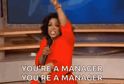 Man In Suit Pointing At Camera Says The Manager GIF