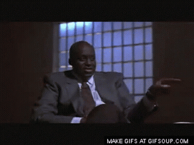 Man In Suit Pointing At Desk GIF