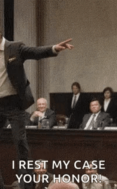Man In Suit Pointing At Jury In Courtroom GIF
