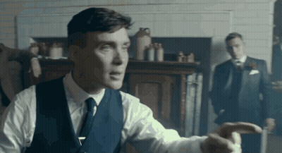 Man In Suit Pointing With Another Man Behind GIF