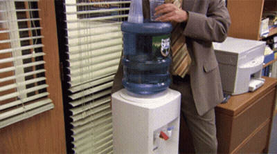 Man In Suit Pouring Water Bottle Ups GIF
