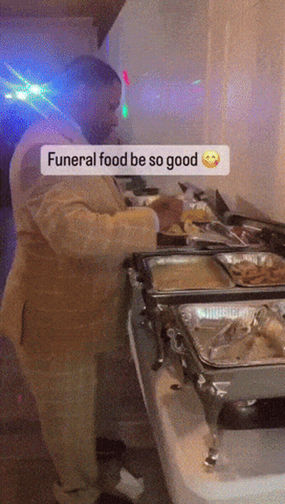 Man In Suit Preparing Food For Funeral GIF