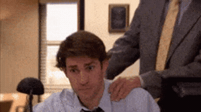 Man In Suit Puts Hand On Colleague's Shoulder GIF