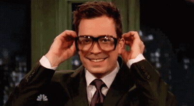 Man In Suit Putting On Glasses GIF