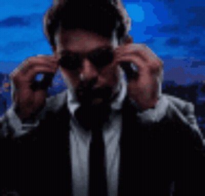 Man In Suit Putting On Sunglasses GIF