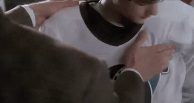 Man in Suit Putting White Jersey on Young Man