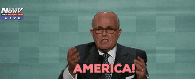 Man In Suit Raising Hands Saying America GIF