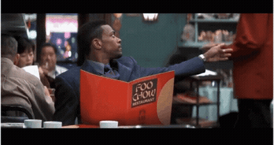 Man In Suit Reading Menu GIF