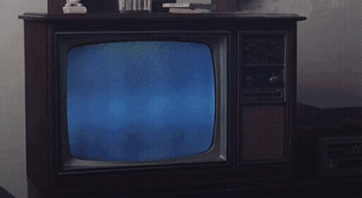 Man In Suit Reading Newspaper On Television GIF