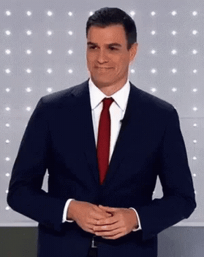Man In Suit Red Tie Smiling Hands Folded GIF