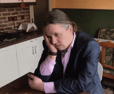 Man In Suit Resting Head On Hands GIF