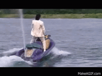 Man In Suit Riding Jet Ski In Lake GIF