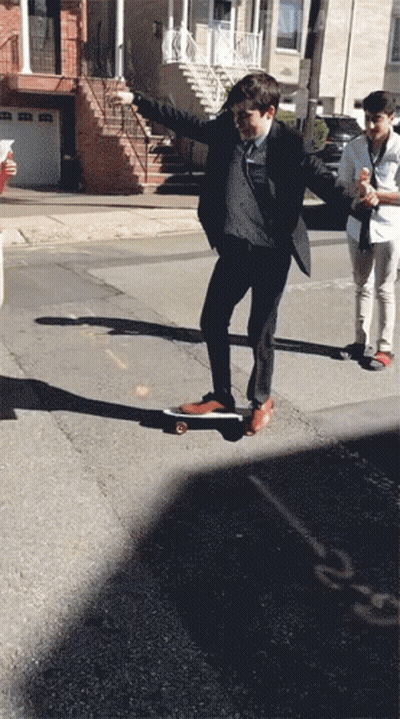 Man In Suit Riding Skateboard GIF