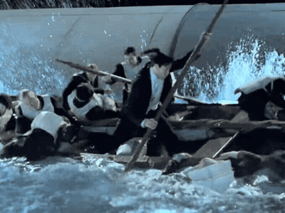 Man In Suit Rowing Boat With Stick GIF