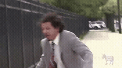 Man In Suit Running Down Street GIF