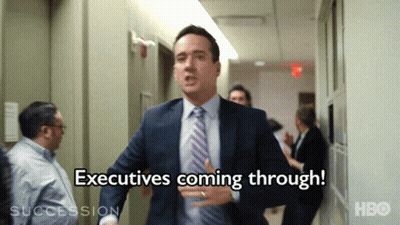 Man In Suit Running Says Executives Coming Through GIF