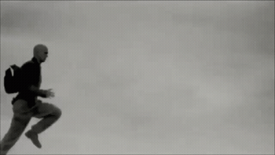 Man In Suit Running Through Air GIF