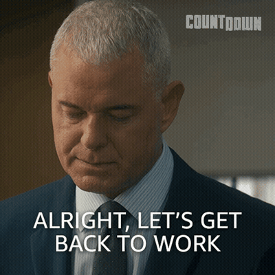 Man in Suit Saying Alright Let's Get Back to Work