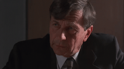 Man In Suit Saying America Couldn't Care Less GIF