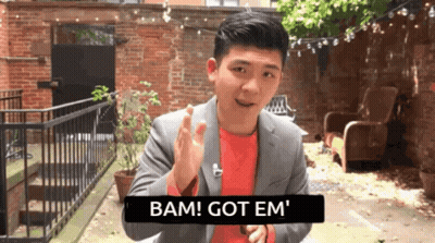 Man In Suit Saying Bam Got Em In Front Of Brick Wall GIF