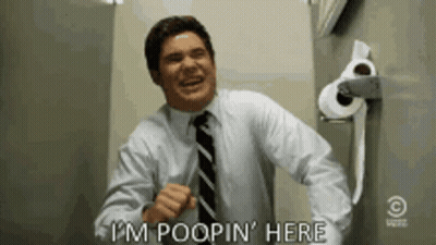 Man In Suit Saying I'm Poopin Here Next To Toilet Paper GIF