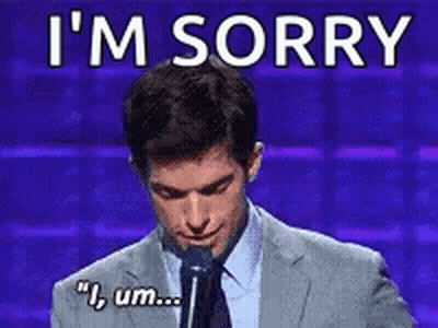 Man In Suit Saying I'm Sorry At Microphone GIF