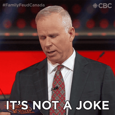 Man In Suit Saying It's Not A Joke Holding Paper GIF