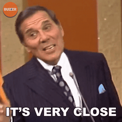Man In Suit Saying It's Very Close At Microphone GIF