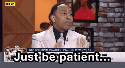 Man In Suit Saying Just Be Patient On TV Screen GIF