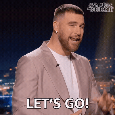 Man In Suit Saying Let's Go In Front Of Are You Smarter Than Celebrity Sign GIF
