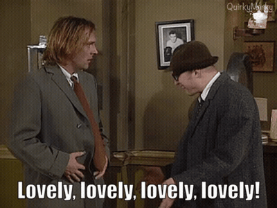 Man In Suit Saying Lovely To Man In Hat GIF