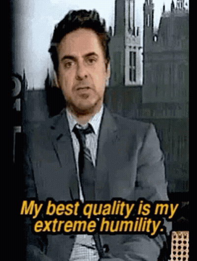 Man In Suit Saying My Best Quality Is My Extreme Humility GIF