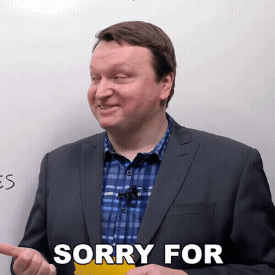 Man In Suit Saying Sorry In Front Of Whiteboard GIF