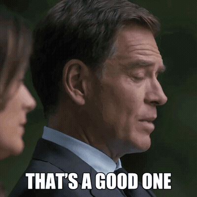 Man In Suit Saying That's A Good One To Woman GIF