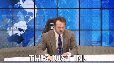Man In Suit Saying This Just In In Front Of World Map GIF