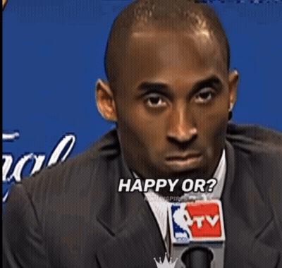 Man In Suit Saying What's Into Microphone GIF
