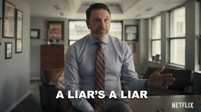 Man In Suit Says A Liar's A Liar Sitting At Table GIF