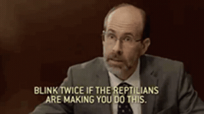 Man In Suit Says Blink Twice If The Reptiles Are Making You Do This GIF