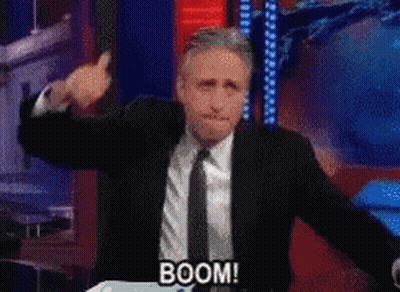 Man In Suit Says Boom Into Microphone GIF