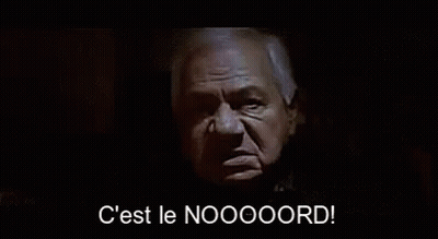 Man In Suit Says C Est Le Noooord In Dark Room GIF