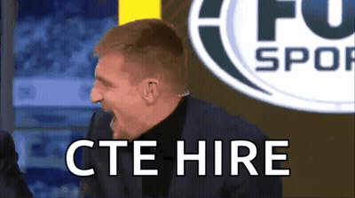 Man In Suit Says CTE Hire In Front Of Soccer Logo GIF