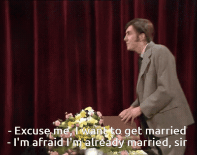 Man In Suit Says Excuse Me With Flowers GIF