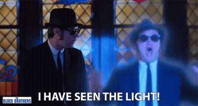 Man In Suit Says I Have Seen The Light In Front Of Stained Glass Window GIF