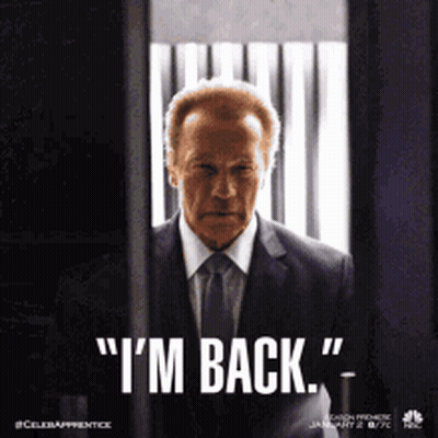 Man In Suit Says I'm Back In Front Of Window GIF